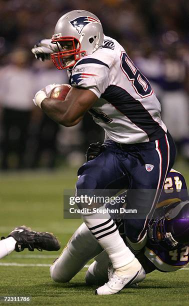 Tight end Benjamin Watson of the New England Patriots is tackled by safety Darren Sharper of the Minnesota Vikings after a gain October 30, 2006 at...