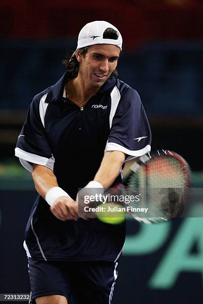 Juan Ignacio Chela of Argentina plays a backhand in his match against Paradorn Srichaphan of Thailand during day two of the BNP Paribas ATP Tennis...