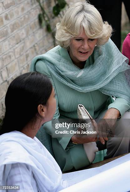 Camilla, Duchess of Cornwall talks to a pupil in the art class at Fatima Jinnah college on the third day of the Royal Tour of Pakistan on October 31,...