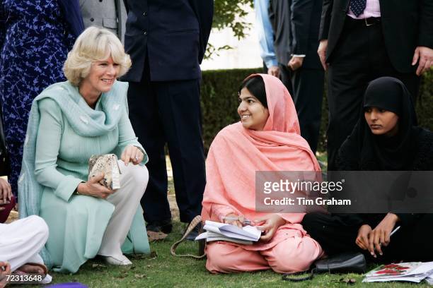 Camilla, Duchess of Cornwall wears a traditional shalwar kameez in turquoise to meet students at the all female Fatima Jinnah University on October...