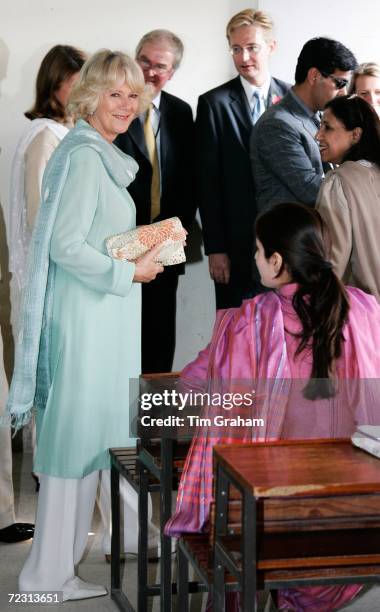 Camilla, Duchess of Cornwall wears a traditional shalwar kameez in turquoise to meet students at the all female Fatima Jinnah University on October...