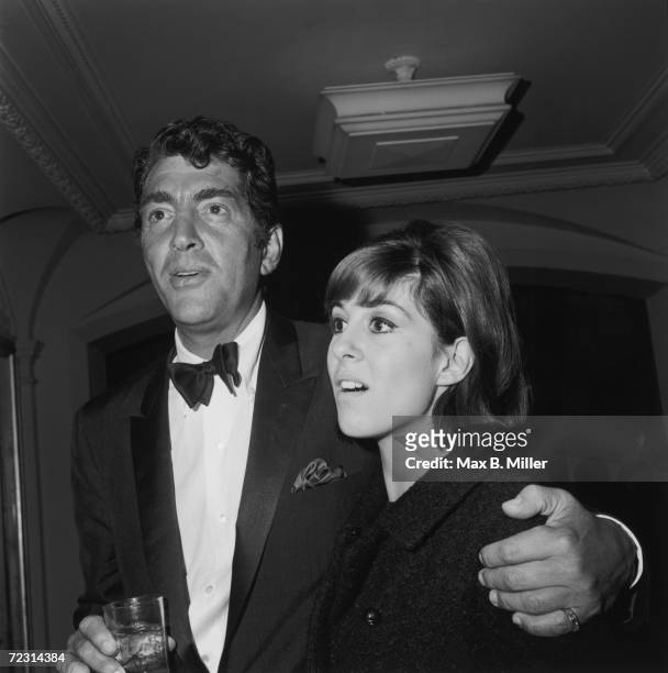 American actor and singer Dean Martin with his arm around his daughter Deana at a Hollywood event, December 1965.