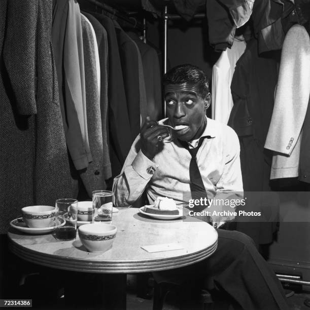 American dancer, singer and actor Sammy Davis Jr eats pound cake a la mode in his dressing room, 4th November 1953.