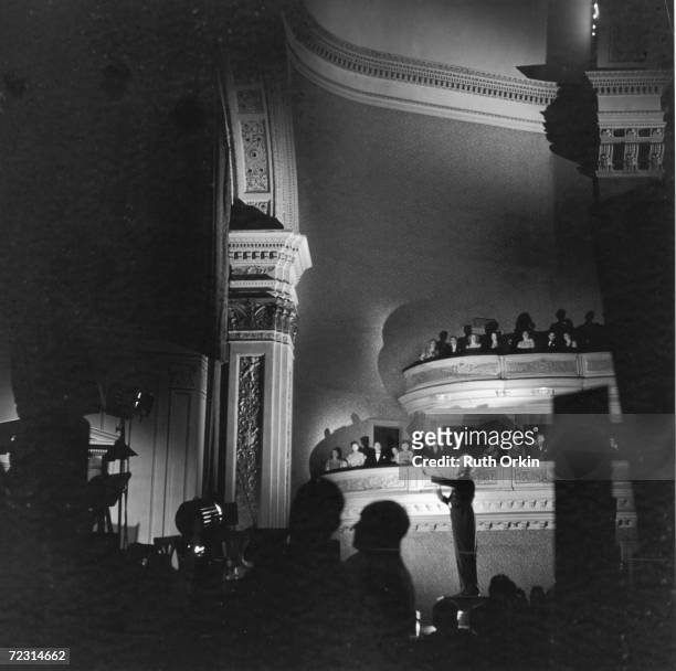 British-born American conductor Leopold Stokowski conducts the New York Philharmonic Orchestra at Carnegie Hall, New York, late 1940s or early 1950s....