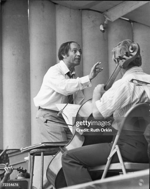 French composer and conductor Pierre Boulez conducts a rehearsal of the New York Philharmonic Orchestra at Lewisohn Stadium, New York, early 1970s....