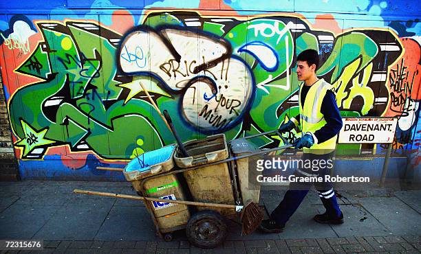 Road sweeper makes his way through a London street heavily vandalised with graffiti, March 31, 2004 in North London, England. New powers came into...