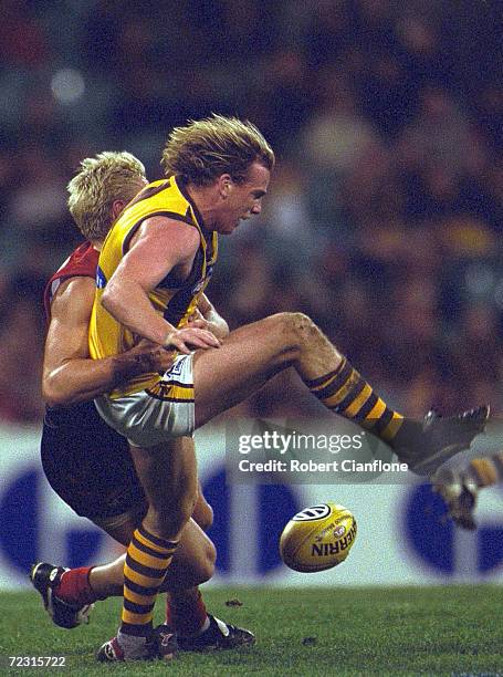 Rayden Tallis for Hawthorn attempts to soccer the ball off the ground, during the AFL round 19 game between the Melbourne Demons and the Hawthorn...