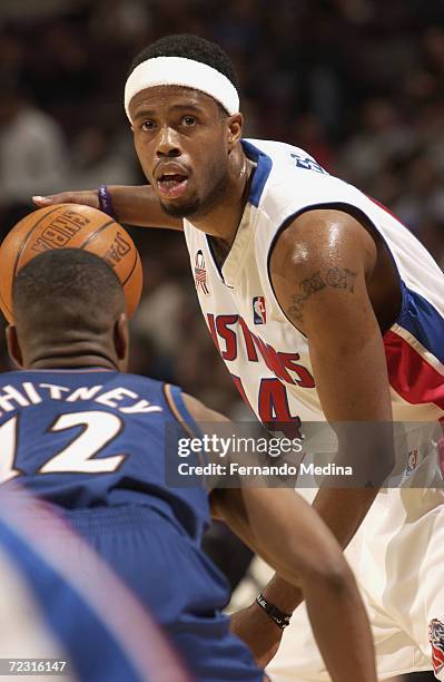Damon Jones of the Detroit Pistons is defended by Chris Whitney of the Washington Wizards during their game at the Palace of Auburn Hills in Auburn...