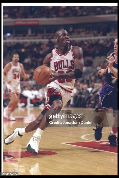 Guard Michael Jordan of the Chicago Bulls moves the ball during a game against the Sacramento Kings at the United Center in Chicago, Illinois. The...