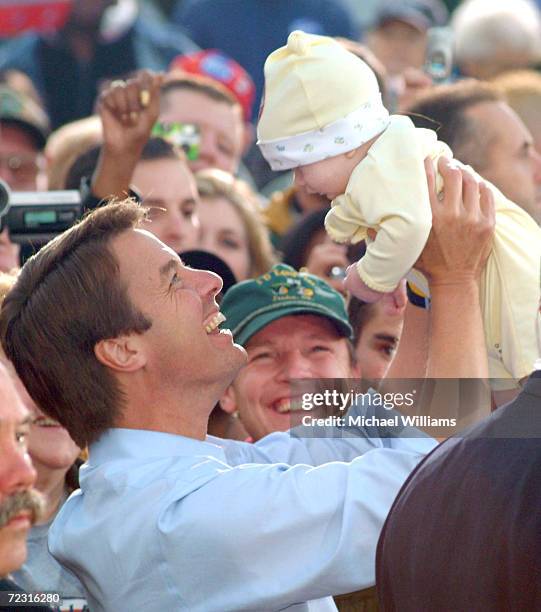 Democratic vice presidential candidate John Edwards playfully holds a baby at a rally October 24, 2004 in Lima, Ohio. Approximately 1,000 people...