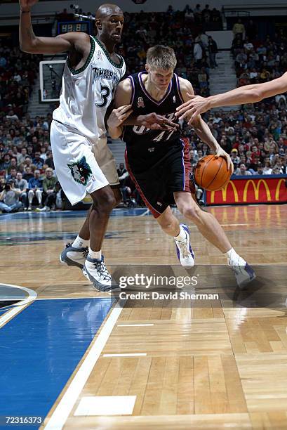 Andrei Kirilenko of the Utah Jazz drives hard to the basket around Joe Smith of the Minnesota Timberwolves at Target Center in Minneapolis,...