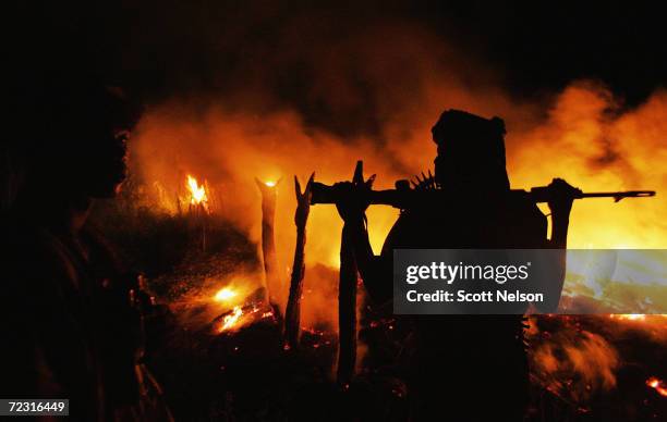 An armed Sudanese rebel from the Justice and Equality Movement arrives at the abandoned village of Chero Kasi less than an hour after Janjaweed...