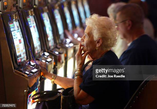Joan Ouellette plays a slot machine May 11, 2004 during the grand opening for the Seminole Hard Rock Hotel and Casino in Hollywood, Florida. South...