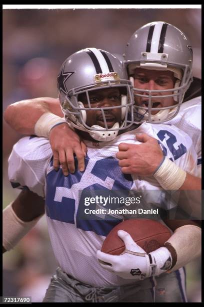 Running back Emmitt Smith of the Dallas Cowboys celebrates with teammate fullback Daryl Johnston during Super Bowl XXVIII against the Buffalo Bills...
