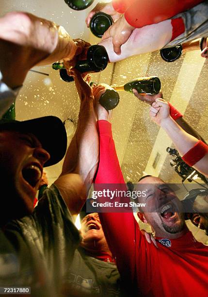 Tim Wakefield of the Boston Red Sox and teammates celebrate in the locker room after defeating the St. Louis Cardinals 3-0 to win game four of the...