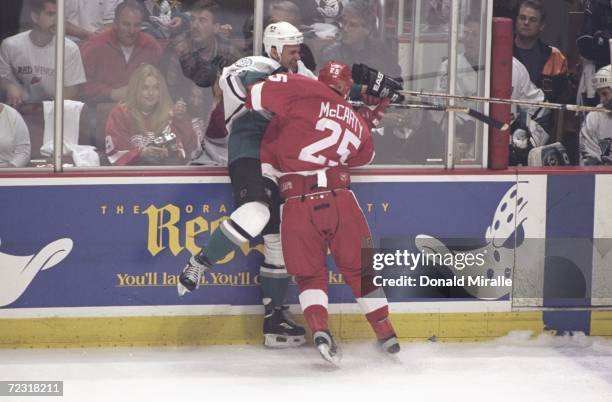 Darren McCarty the Detroit Red Wings pushes Fredrick Olausson of the Anaheim Mighty Ducks during the Stanley Cup Playoffs at the Arrowhead Pond in...