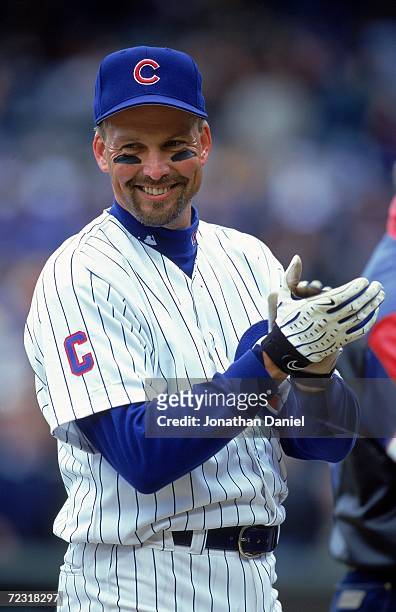 Mark Grace of the Chicago Cubs smiles as he claps on the field before the game against the Atlanta Braves at Wrigley Field in Chicago, Illinois. The...