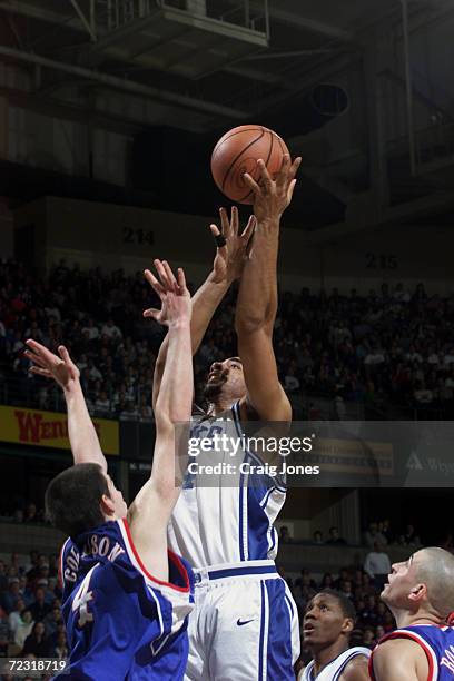 Center Carlos Boozer of the Duke Blue Devils shoots the ball as forward Nick Collison of the Kansas Jayhawks defends during their second-round NCAA...