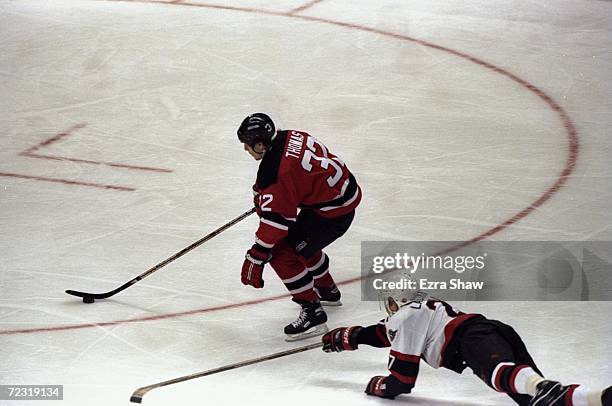 Defenseman Janne Laukkanen of the Ottawa Senators and leftwinger Steve Thomas of the New Jersey Devils in action during a playoff game at the Corel...