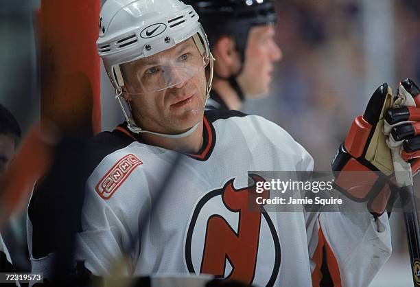 Claude Lemieux of the New Jersey Devils looks on from the wall during a game against the Dallas Stars at the Continental Airlines Arena in East...