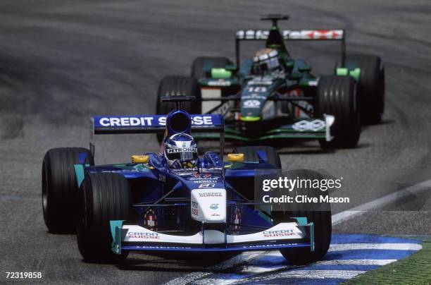 Sauber driver Kimi Raikkonen of Finland leads Jaguar driver Eddie Irvine of Great Britain during the Formula One German Grand Prix held at...