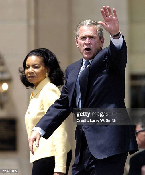 President George W. Bush waves to the crowd as he leaves the stage along with Cheryl Brown Henderson, one of the children of the late Reverend Oliver...