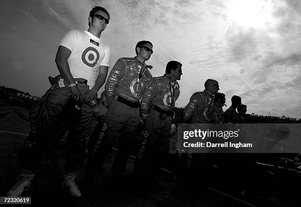 Dan Wheldon, driver of the Target Ganassi Racing Dallara Honda lines up with his team before the start of the IRL IndyCar Series Firestone Indy 400...