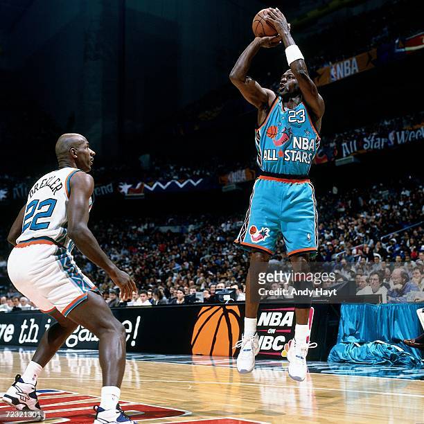 Michael Jordan of the Eastern Conference All Stars shoots a jump shot against Clyde Drexler of the Western Conference All Stars during the 1996 NBA...