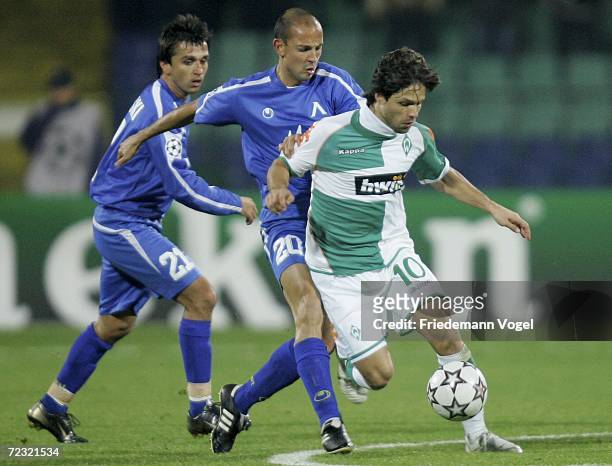Diego of Bremen tussles for the ball with Dimitar Telkiyski and Stanislav Angelov of Sofia during the UEFA Champions League Group A match between...