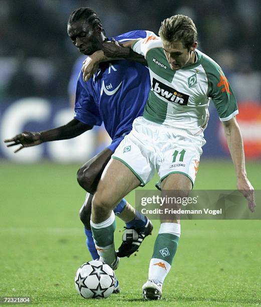 Miroslav Klose of Bremen tussles for the ball with Richard Eromoigbe of Sofia during the UEFA Champions League Group A match between Levski Sofia and...