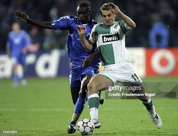 Miroslav Klose of Bremen tussles for the ball with Richard Eromoigbe of Sofia during the UEFA Champions League Group A match between Levski Sofia and...