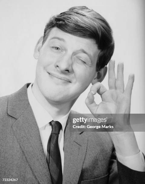 1950s: Young man making the O.K. Sign.