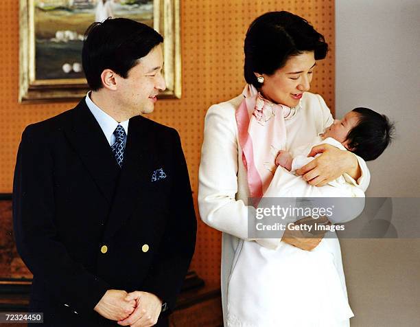 Japans Crown Prince Naruhito smiles at his baby daughter Princess Aiko, held in the arms of Crown Princess Masako at their Togu Palace residence...