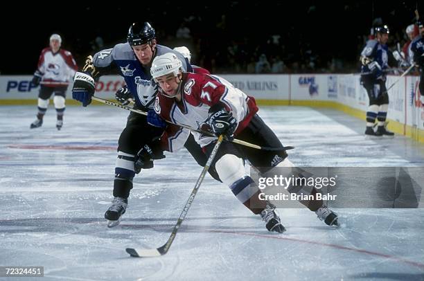 Defenseman Cory Cross of the Tampa Bay Lightning in action against center Chris Drury of the Colorado Avalanche during the game at the McNichols...