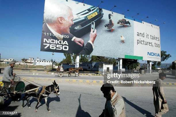 On the rural outskirts of Islamabad, Pakistan, a giant Nokia cell phone advertisement is a landmark along the historic Grand Trunk Highway, March 4,...