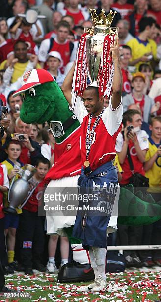 Thierry Henry of Arsenal walks around the ground with the trophy on his head as he celebrates winning the Premiership during the FA Barclaycard...