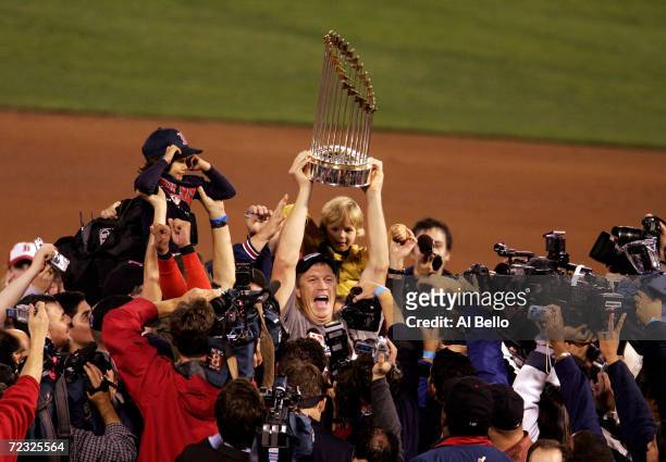 Mike Timlin of the Boston Red Sox celebrates with the trophy after defeating the St. Louis Cardinals 3-0 in game four of the World Series on October...