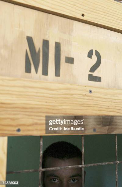 Prisoner looks out from a cell in the Abu Ghraib prison on July 15, 2004 west of Baghdad, Iraq. Pictures of American soldiers abusing prisoners from...