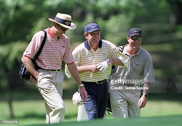 Nick Price walks with David Leadbetter and caddie Jimmy Johnson during the PGA Championships at the Medinah Country Club in Medinah, Illinois....