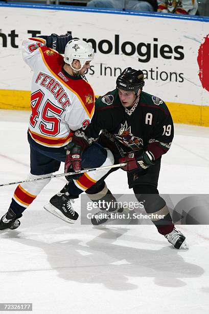 Shane Doan of the Phoenix Coyotes battles Brad Ference of the Florida Panthers during the game at National Car Rental Center in Sunrise, Florida. The...