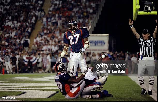 Safety Steve Atwater and cornerback Ray Crockett of the Denver Broncos in action during the game against the New England Patriots at Mile High...