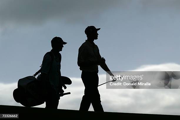 Bob Estes of the USA and caddie walk down the 17th fairway during the third round of the Mercedes Championship at the Plantation Course at Kapalua on...