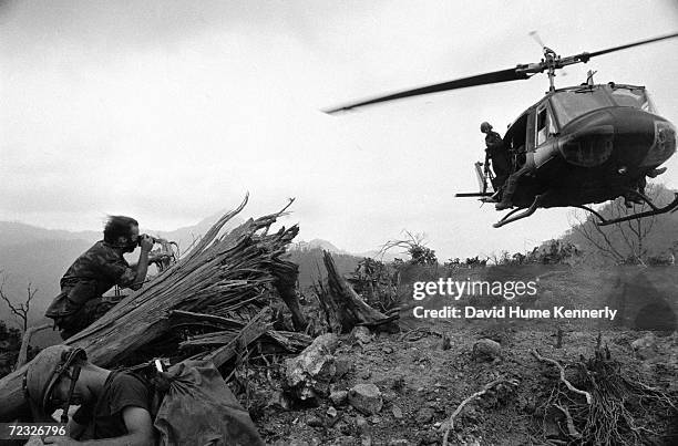 Photograher David Hume Kennerly photographs a helicopter from a hot landing zone in 1971 in the Central Highlands of Vietnam.