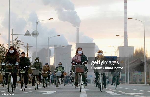 Workers leave after a days work at a steel mill of the Baotou Iron and Steel Group on November 26, 2004 in Baotou, China. The group is one of the...