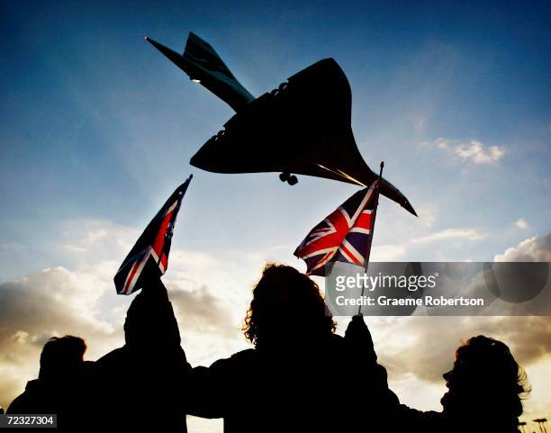 Spectators watch the last ever British Airways commercial Concorde flight touch down at Heathrow airport October 24, 2003 in London. The world's only...