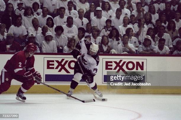 Defenseman Viacheslav Fetisov of the Detroit Red Wings and defenseman Norm MacIver of the Phoenix Coyotes in action during a playoff game at the...