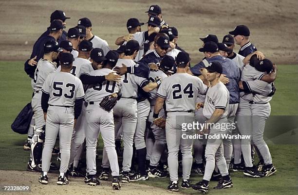 The New York Yankees celebrate after defeating the Texas Rangers in game three of the American League Divisional Series at The Ball Park in the...