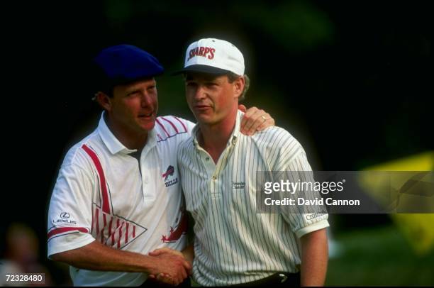 Lee Janzen of the USA is congratulated by Payne Stewart during the 1993 U.S. Open at the Batusrol Golf Club in Springfield, New Jersey. Janzen went...