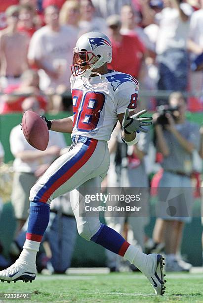 Terry Glenn of the New England Patriots carries the ball for a touchdown during a game against the Kansas City Chiefs at Arrowhead Stadium in Kansas...