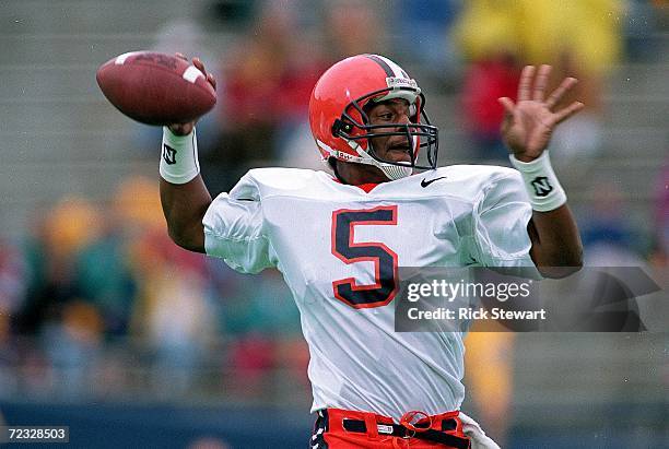 Donovan McNabb of the Syracuse Orangemen passes the ball during a game against the Pittsburgh Panthers at the Pitt Stadium in Pittsburgh,...